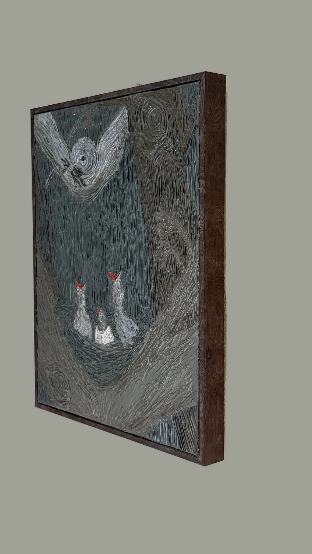 Framed artwork of a bird and two chicks on a textured gray background