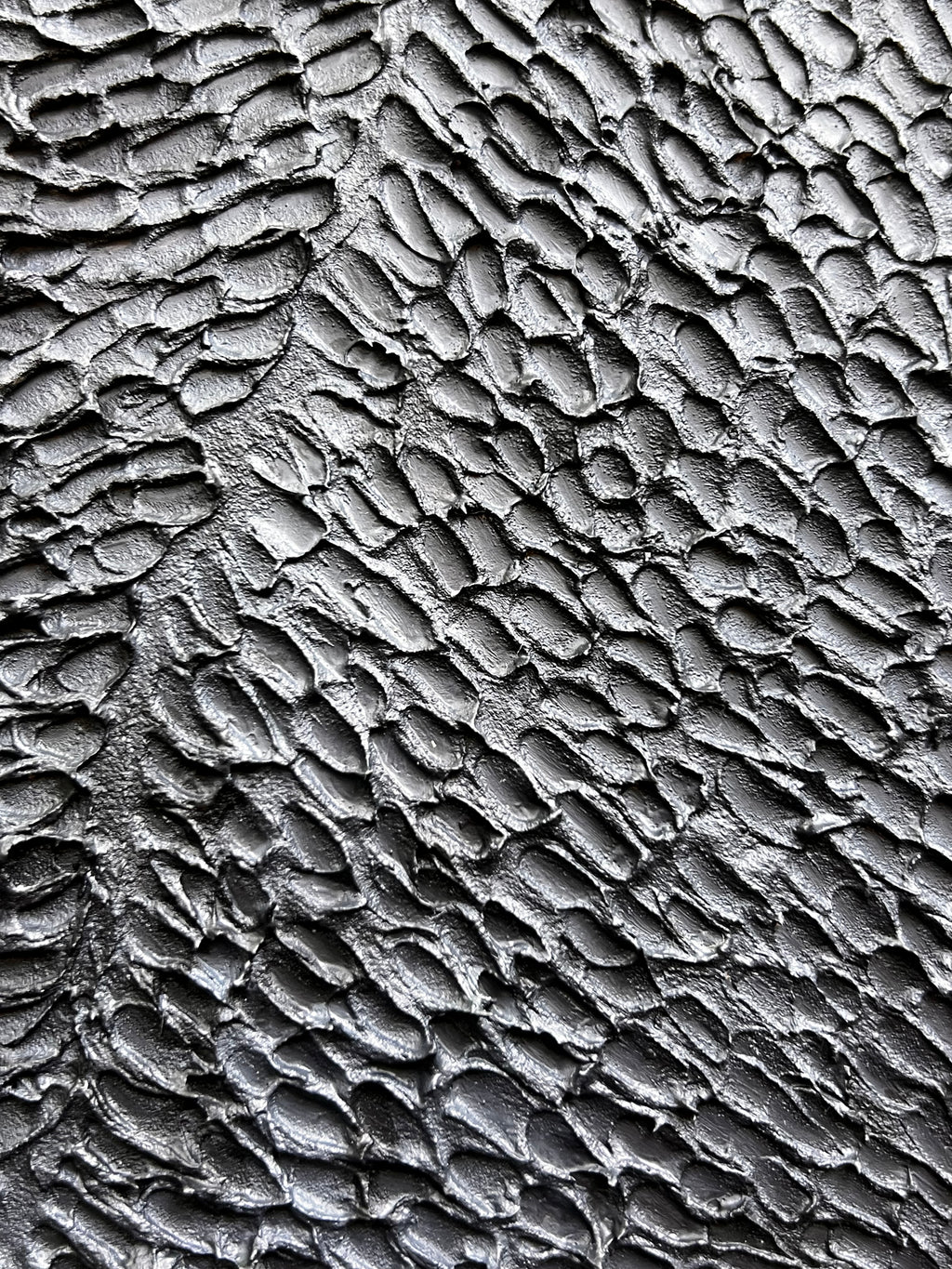 Textured contemporary relief artwork inspired by traditional wood carving techniques and organic material forms.