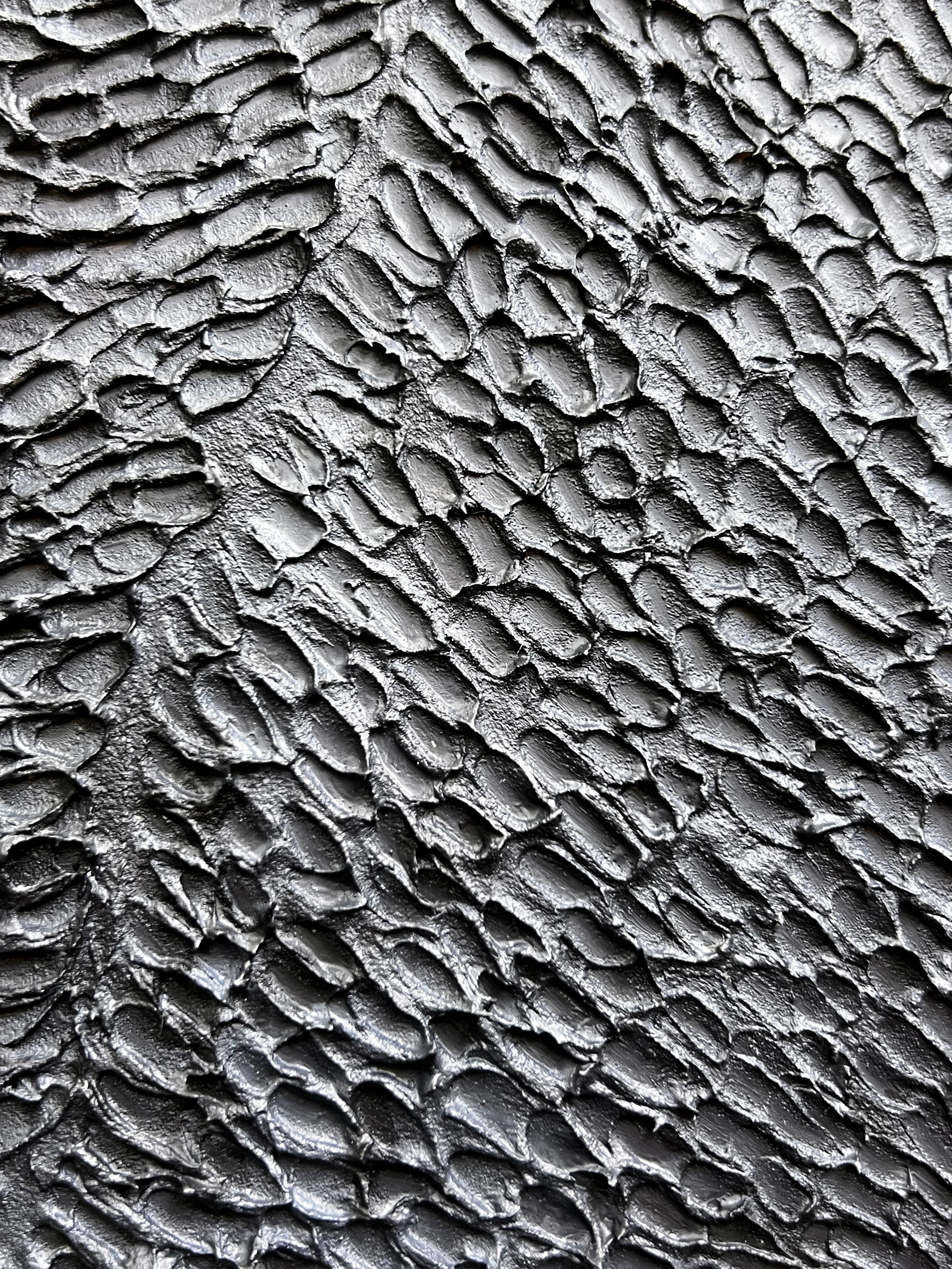 Textured contemporary relief artwork inspired by traditional wood carving techniques and organic material forms.
